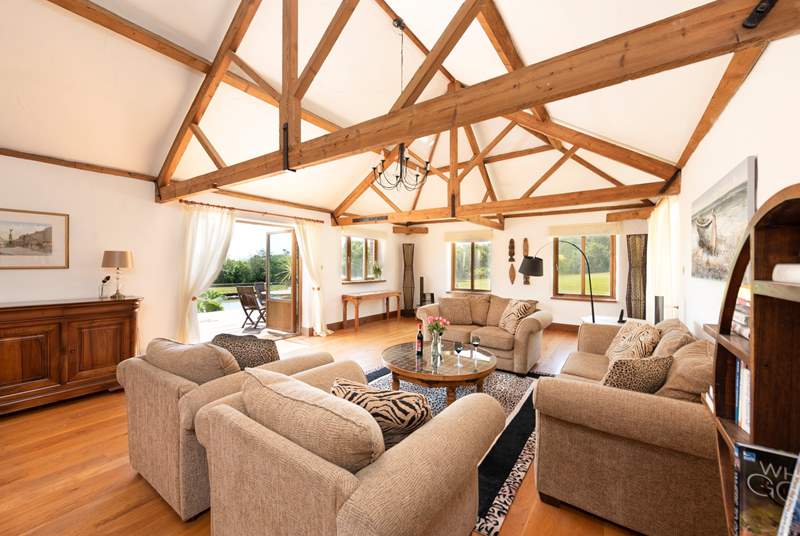 The light and airy sitting-room has double doors that open onto the decking, overlooking the pond.