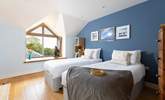 The blue bedroom can be set up as twins or a super king bed and has far reaching views to the sea on a clear day.  - Thumbnail Image