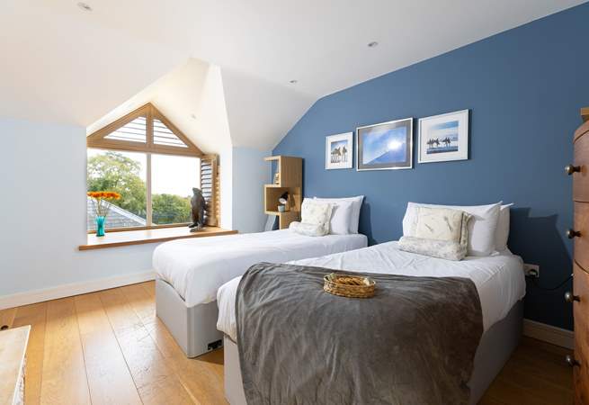 The blue bedroom can be set up as twins or a super king bed and has far reaching views to the sea on a clear day. 