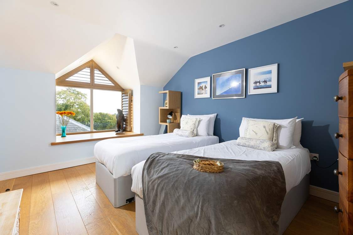 The blue bedroom can be set up as twins or a super-king bed and has far reaching views to the sea on a clear day.