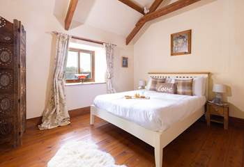 This bedroom has a king size bed and views out over the cobbled courtyard. 