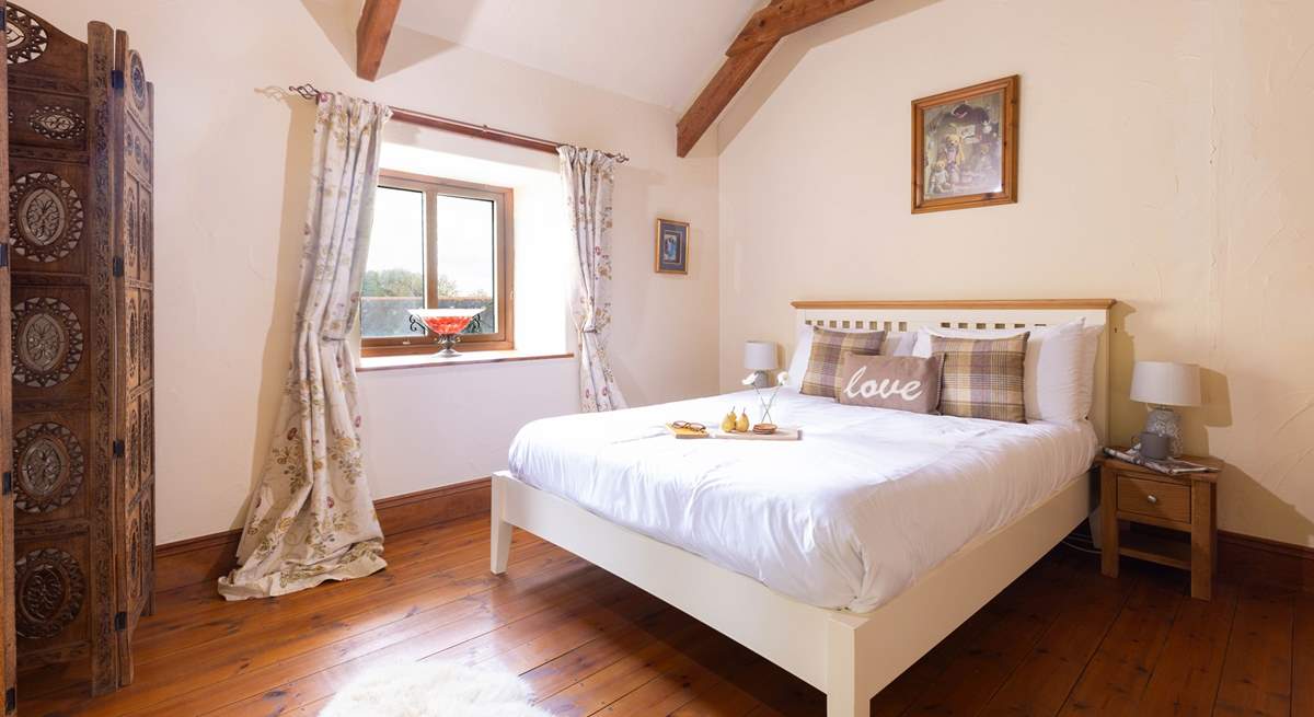 This bedroom has a king size bed and views out over the cobbled courtyard. 