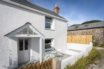 The front aspect of Bower Cottage. Here you have a little bistro table where you can enjoy the evening sun and a glass of wine.