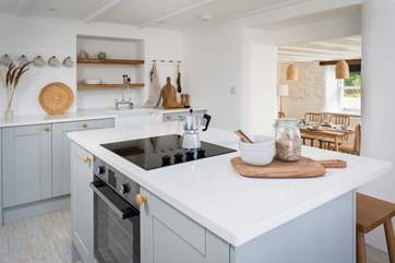 If you fancy a more informal lunch, you can hop on one of the three breakfast stools. Three steps lead from the kitchen into the dining area.