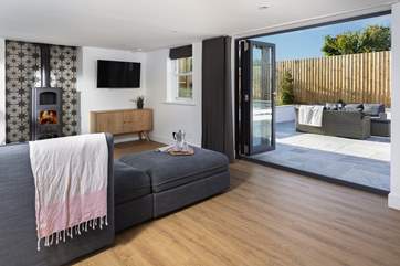 If you feel like letting the outdoors in, open up the bi-fold doors.