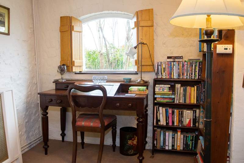 Writing desk and plenty of books for all ages to keep you entertained.