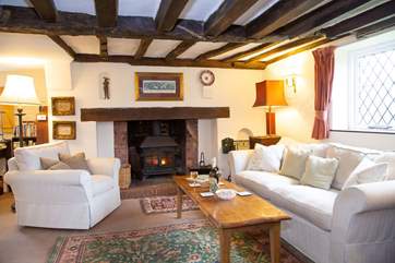 Large sitting-room with welcoming wood-burner.