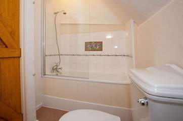 En suite bathroom with shower attachment.