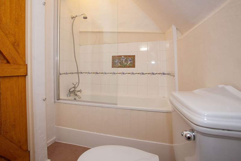 En suite bathroom with shower attachment.