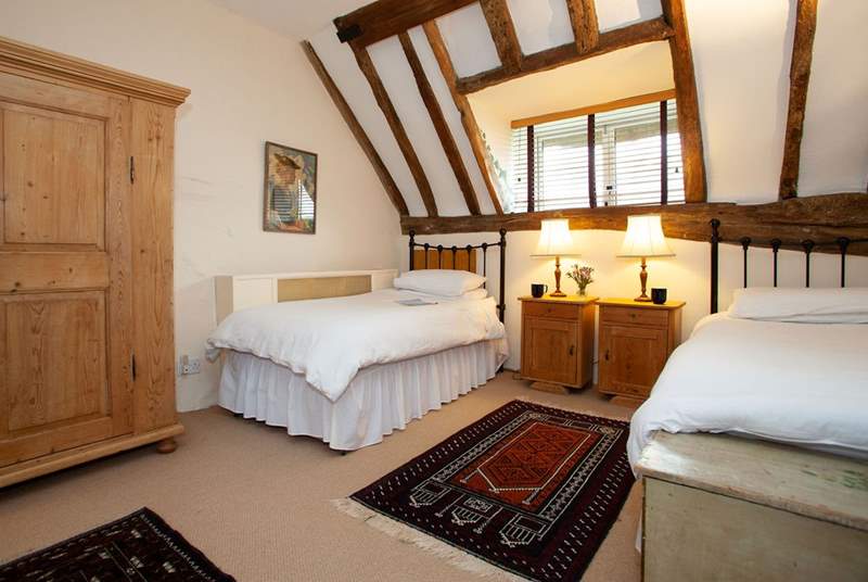 Spacious twin bedroom with views onto the garden.