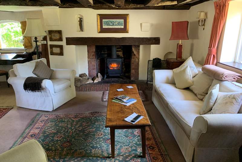 Large sitting-room with a welcoming wood-burner effect electric stove.