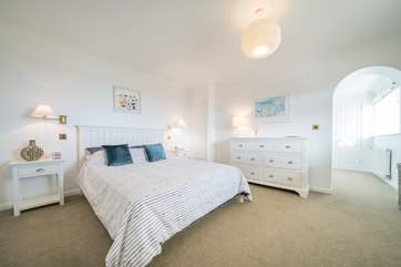 The ground floor master bedroom with king-size bed, dressing-room and en suite shower-room.