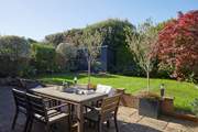 Dine al fresco while watching the children play on the lawn.