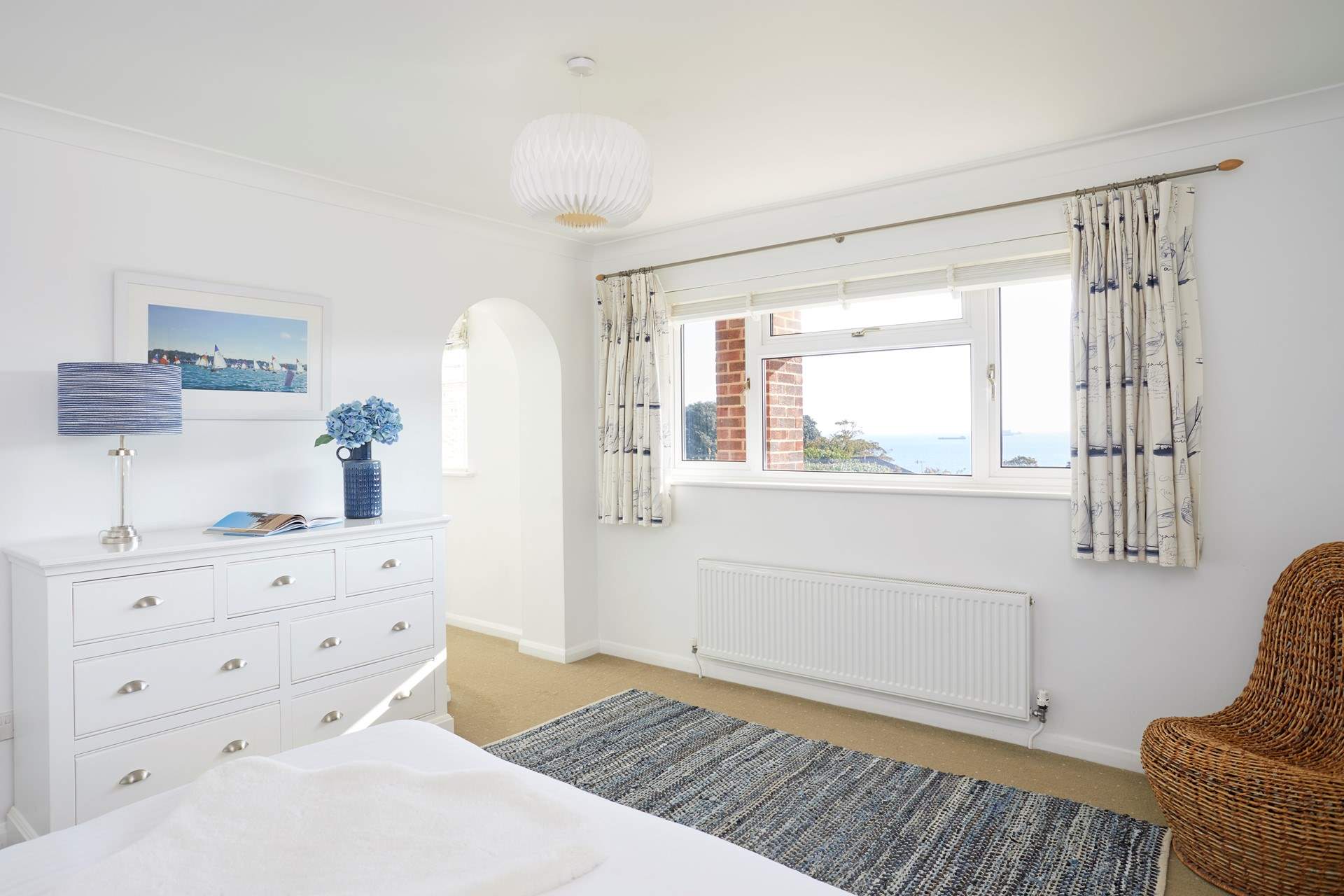 This room is full of natural light, with views of the sea.