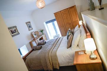 The master bedroom with en suite offers a larger than average size bedroom which has been decorated beautifully.