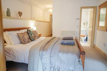 The master en suite bedroom is a spacious room at the opposite end of the barn to the sitting-room.
