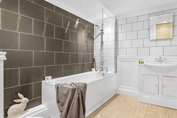 The family bathroom with a bath and overhead shower.