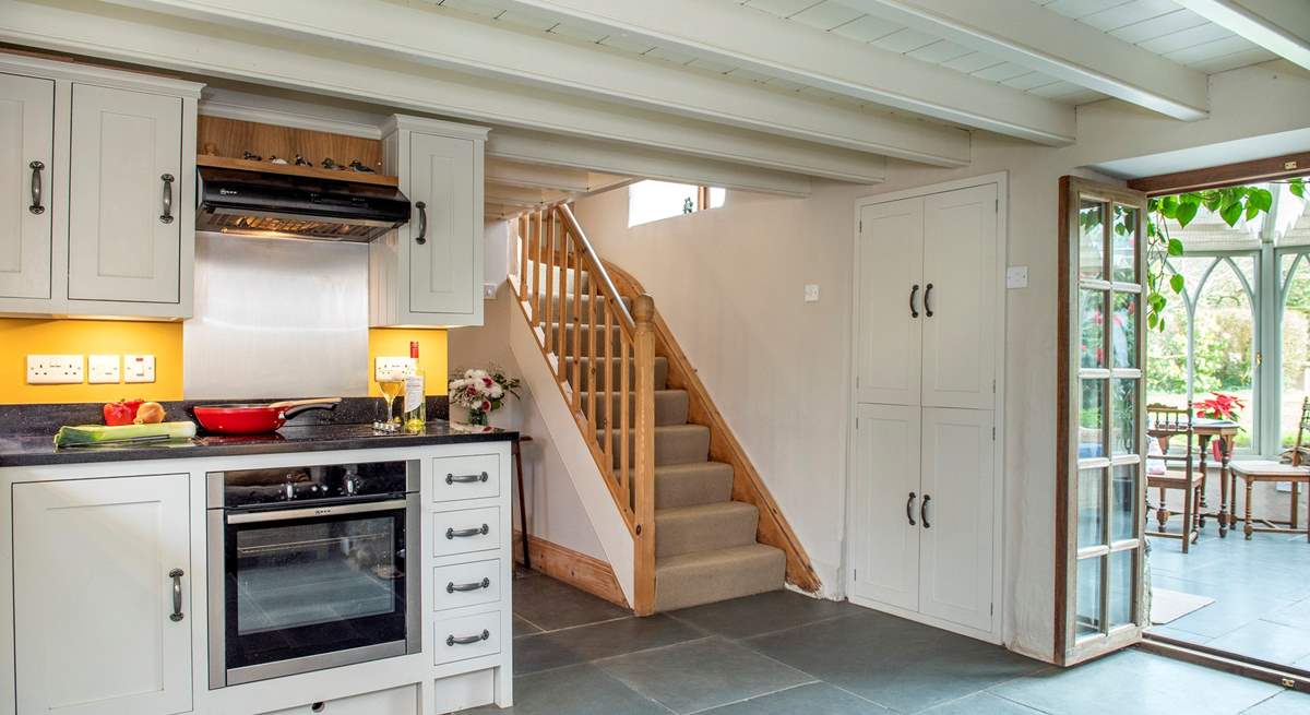 The kitchen opens to the conservatory and the stairs lead to the bedrooms and family bathroom. 