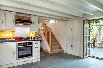 The kitchen opens to the conservatory and the stairs lead to the bedrooms and family bathroom.