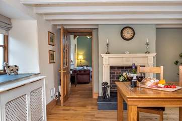 You will find the sitting-room through the dining-room.
