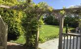 Scented wisteria in bloom surrounds the house. - Thumbnail Image