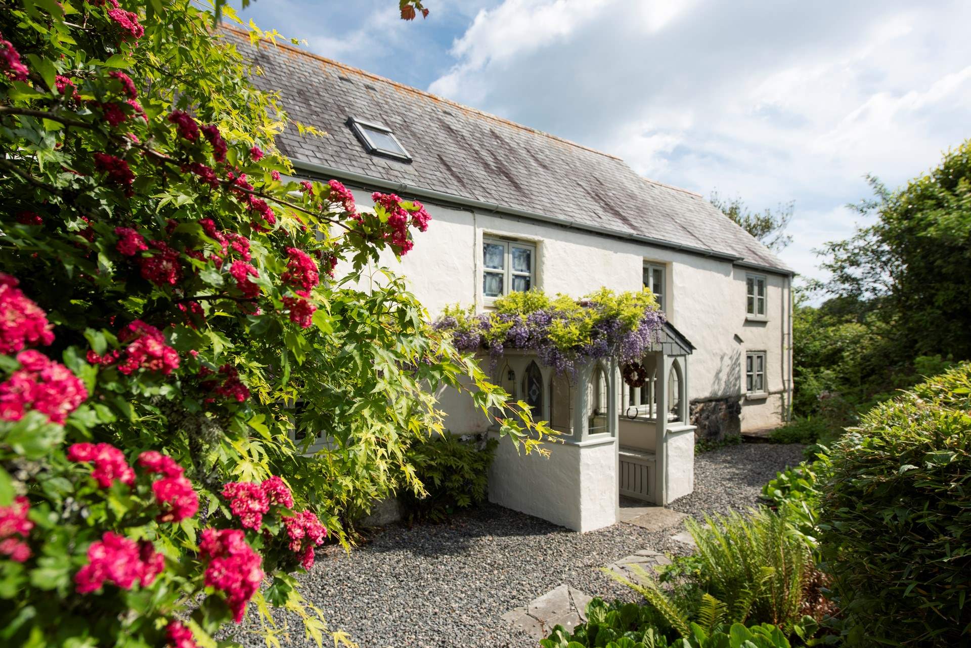 The front elevation, adorned in wisteria.
