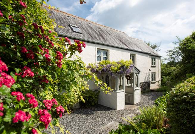The front elevation, adorned in wisteria.