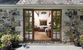 The sitting-room opens directly onto the large rear patio. - Thumbnail Image