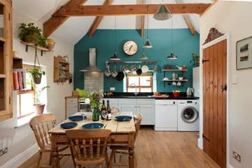 The open plan living space is light and airy with stunning exposed beams.