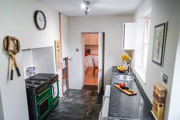 The utility-room links to the kitchen and offers a functional storage area as well as additional cooking. The utility-room door opens directly into the courtyard.