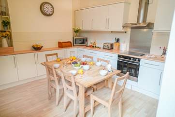 The kitchen is well laid out with space for people to move around and also sit and talk.