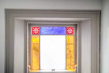 The wonderful stained glass window in the shower-room.