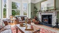The gorgeous sitting-room is situated to the front of the house and has stunning views of the garden and beyond.  Not forgetting the log-burner and the 65
