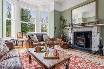 The gorgeous sitting-room is situated to the front of the house and has stunning views of the garden and beyond. Not forgetting the log-burner and the 65