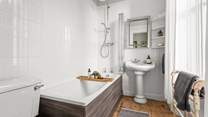 Bedroom 1 has a stylish en suite and that all important bath.