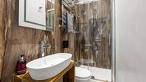 Bedroom 2 has an en suite shower that offers a touch of luxury.