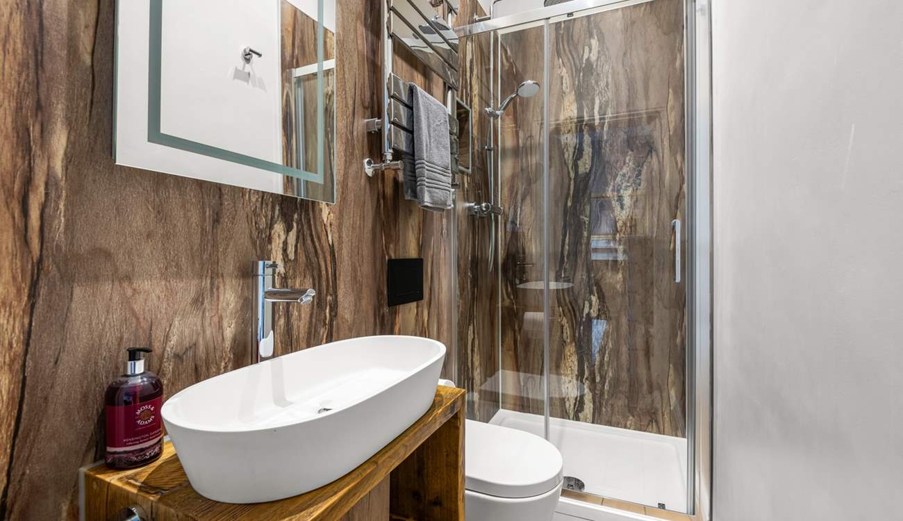 Bedroom 2 has an en suite shower that offers a touch of luxury.