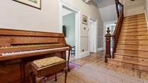 The sweeping staircase leads to the first floor.