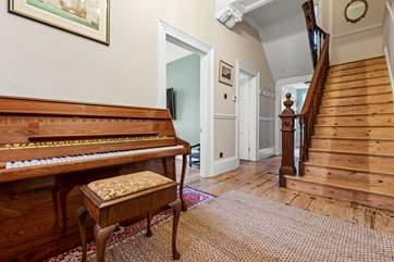 The sweeping staircase leads to the first floor.
