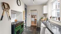 The kitchen adjoins a handy utility-room.