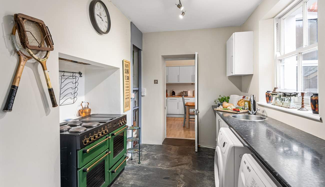 The kitchen adjoins a handy utility-room.