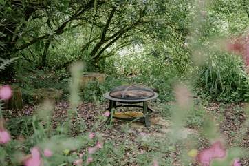 There are plenty of gorgeous hideaways to discover outside, like this delightful firepit.