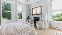 Bedroom 1 with a king-size bed and en suite bathroom offers fabulous views.