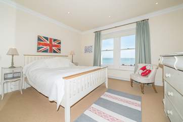The first floor master bedroom with king-size bed and en suite shower-room.