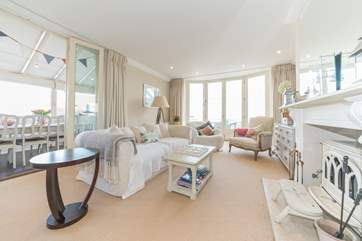 The spacious second sitting-room with wood-burner and piano.