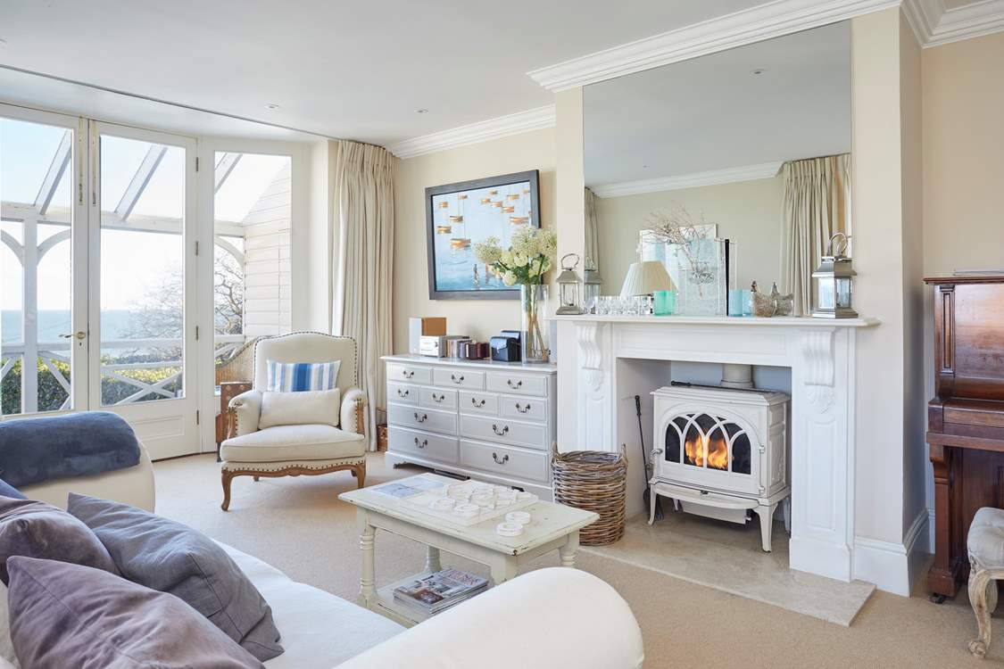 The spacious second sitting-room with wood-burner and piano.