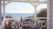 Walk out onto the balcony from the ground floor to breathtaking views across Seagrove Bay.