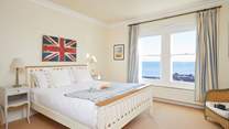 The first floor master bedroom with king-size bed and en suite shower-room.