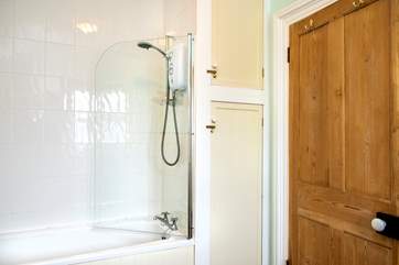 The cottage bathroom has a fitted shower over the bath.