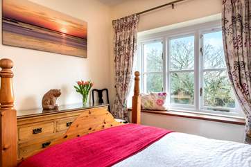 Bedroom 1 has a gorgeous wooden bedstead.